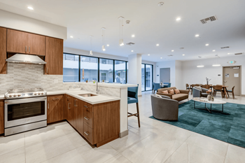 a kitchen and living room with a view of the ocean